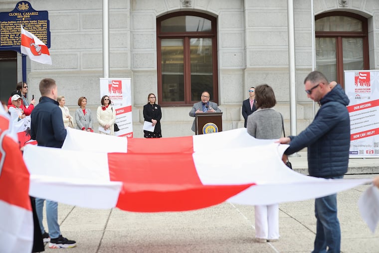 Councilmember David Oh speaks at a ceremony on Friday at which the 1918 red-and-white flag of Belarus, not the current red-and-green flag of the pro-Russia regime, was flown as a symbol of support for pro-democracy protesters in that nation.