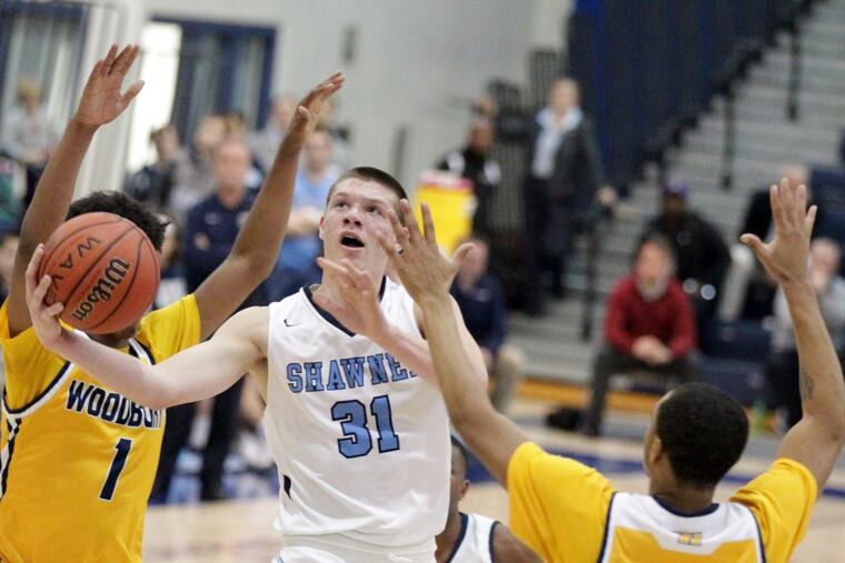 Dean Noll of Shawnee driver past Aaron Estrada (left) and Andre Parker of Woodbury in the Tournament of Champions quarterfinals at Toms River North.