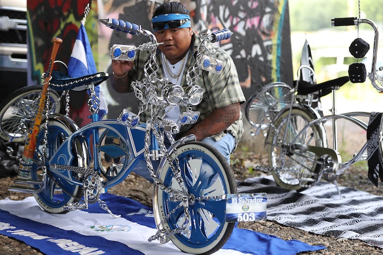 Victor Mauricio Jovel, of Philadelphia, preps his bike at the Champions Lowriders Club event at FDR Park in Philadelphia on Sunday.