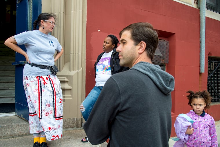 Henry C. Lea Elementary School teacher Kitty Heite (left) talks with parents outside the school September 24, 2018. She is being forced to leave as the school undergoes "leveling" – the shifting of teachers to other schools based on fluxes in enrollment.