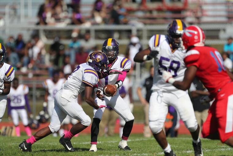 Camden quarterback Premier Wilson hands off to Najyyere Edwards in the second quarter against Pennsauken.