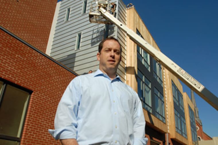 Ben Ryan stands outside 333 Green St., the gated community of townhouses he developed on speculation. (Ron Tarver / Staff Photographer)