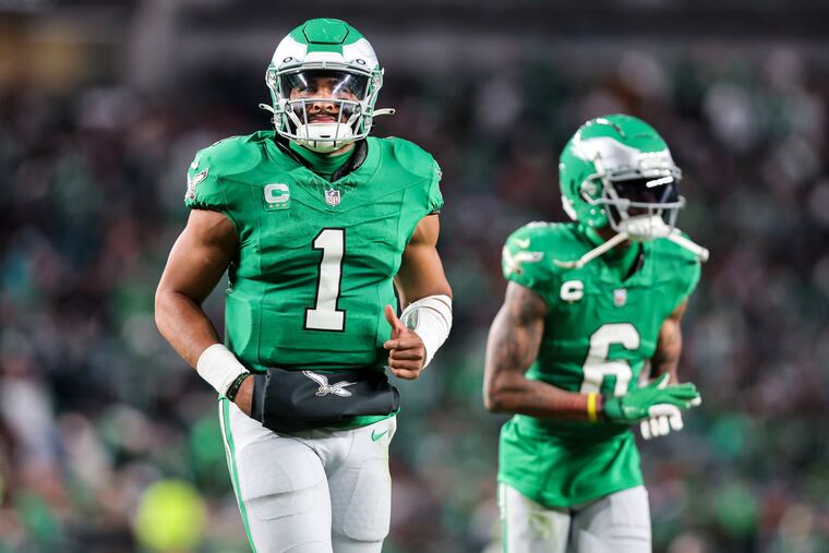 Eagles quarterback Jalen Hurts (left) and wide receiver DeVonta Smith sporting kelly green uniforms during the win over the Dolphins.