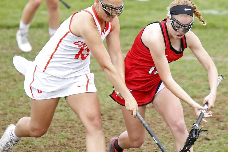 Cherokee's Christina Orio (left) beats Lenape's Allison Cowan to a loose ball during the first half of a girls' lacrosse game Saturday, April 29, 2017 at Cherokee. Lenape went on to win, 18-8. LOU RABITO / Staff