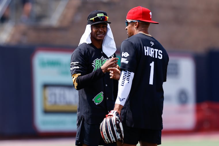 Eagles wide receiver DeVonta Smith with quarterback Jalen Hurts during the DeVonta Smith & Friends celebrity softball game at Coca-Cola Park in Allentown on Saturday.