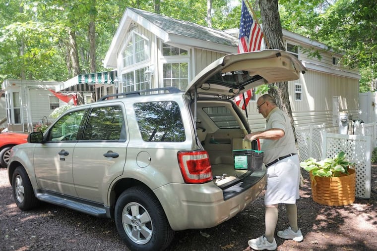 At Avalon Campground in North Clermont, Jules Carcanague prepares some items for a yard sale in Ocean City. He and his companion of 20 years, Vicki O’Connell, live in the campground for 3.5 months of the year and spend the rest of the time in Florida.