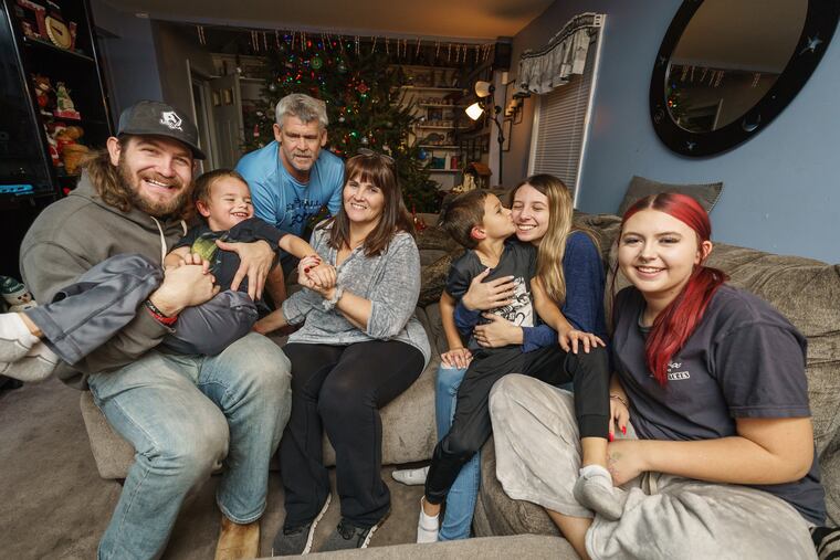 (Left to Right) Chris Pruitt, Elijah Pruitt, 3, Bud Pruitt, Patty Pruitt, Brayden Leon, 6, Makayla Montgomery, 17, and Angelina Montgomery, 15, gather together at home, December 22, 2021.