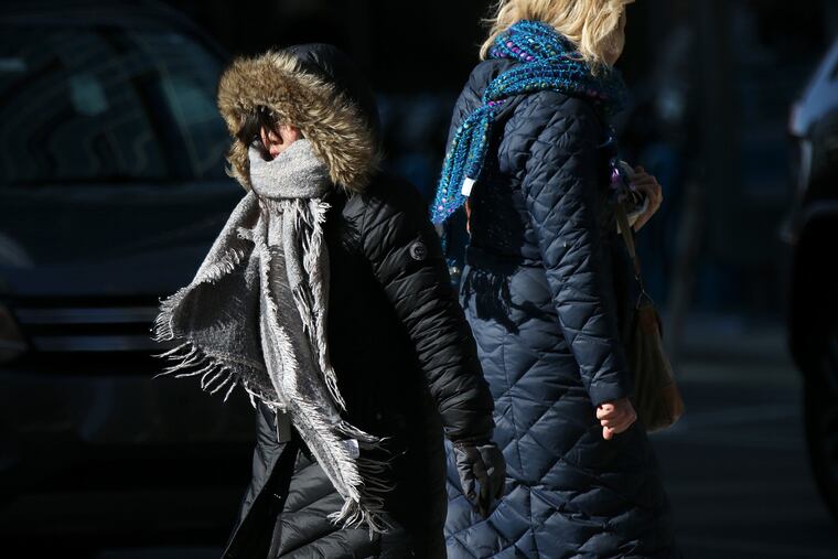 Pedestrians are bundled up as they walk across Market Street in Center City Philadelphia on Wednesday.