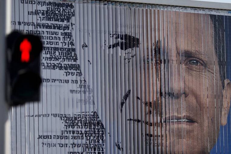 File: An election campaign billboard shifts between images of Isaac Herzog, leader of the Labor Party, right, and Israel's Prime Minister Benjamin Netanyahu and leader of the Likud Party, in Tel Aviv, Israel. As no candidate is likely to win big in the wild jumble of Israel's political landscape, the outcome of the March 17 election could well be a joint government between Netanyahu and his moderate challenger Isaac Herzog. (AP Photo/Ariel Schalit)