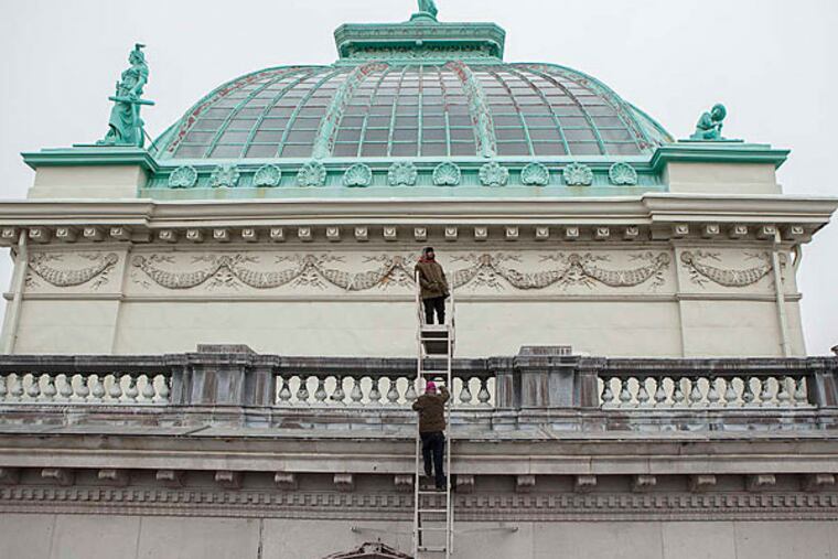 Officials of Please Touch Museum and KSK Architects Planners Historians Inc. check the roofs around the leaky outer dome of Memorial Hall. (CHRIS FASCENELLI / Staff Photographer)