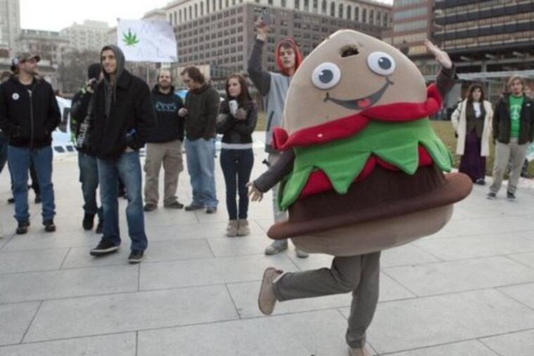 Supporters of the repeal of federal marijuana prohibition laws rally at Independence Mall on Dec. 15, 2012. In an act of civil disobedience, many chose to light joints at 4:20 p.m. disregarding police presence nearby. ( Hillary Petrozziello / Philly.com )