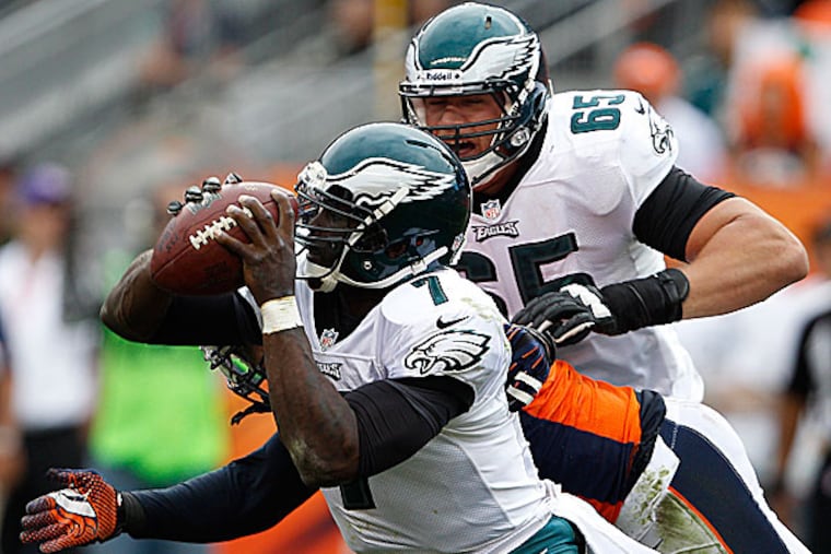 Eagles quarterback Michael Vick and offensive lineman Lane Johnson. (David Maialetti/Staff Photographer)