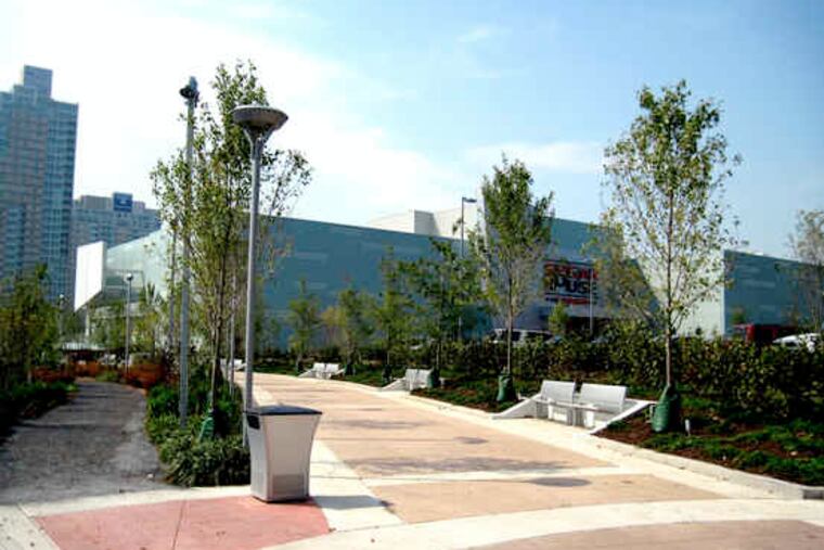 The soft gravel running path (far left) and harder biking and walking surface of the riverwalk will eventually be shielded from the casino when the landscaping matures.