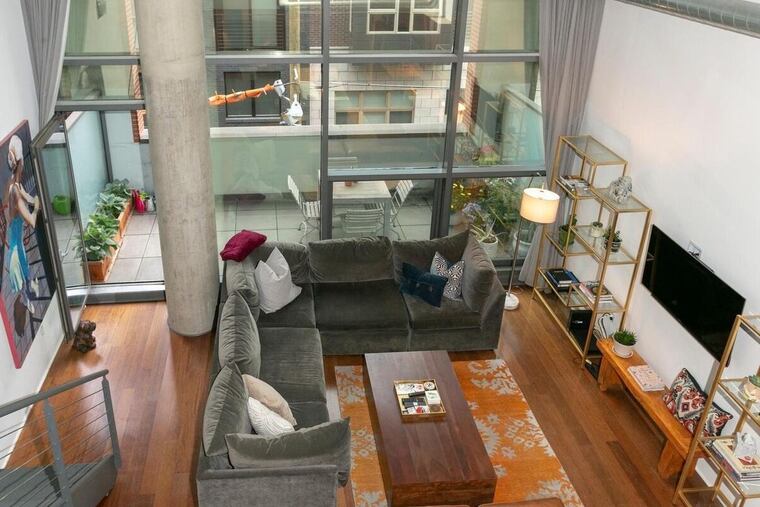 The 1,537-square-foot unit features a two-story living room with floor-to-ceiling windows.