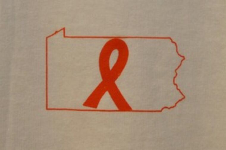 On the front , an orange ribbon and outline of Pennsylvania. The back has the word "United" and college logo.