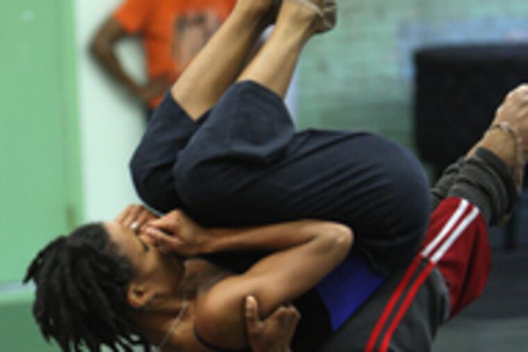 Meredith Rainey and Heidi Cruz-Austin, above, dance in rehearsals at the Performance Garage. Their long duet is the "real meat" of Adam Hougland's "Risk of Flight." Right, Rosalia Chann (front) and Leyland Simmons (on floor) are reflected in mirrors. Chann, BalletX's youngest dancer, is grateful for the larger parts and more interesting dancing of a small company.