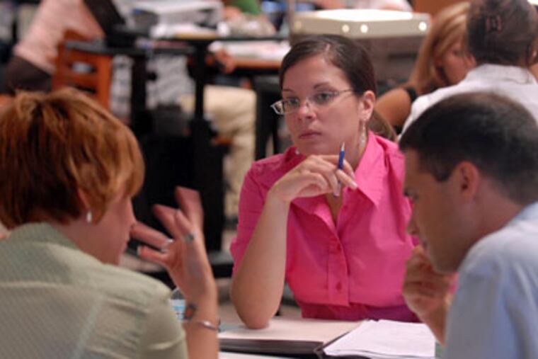 Jen Wristbridge, a new social studies teacher at Williamstown High School, listens to other new teachers in a group activity during three days of orientation. (Ron Tarver/Inquirer)