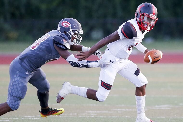 Imhotep’s Jalen Sutton-Christian runs past Gratz defender Kaseem Rogers during the first quarter of Imhotep’s win.