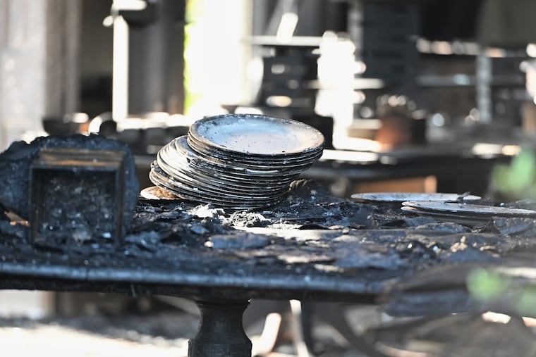 Charred tables and dishes are visible Sunday inside the Pennsylvania governor's official residence in Harrisburg after a man was arrested in an alleged arson that forced Gov. Shapiro, his family, and guests to flee in the middle of the night during the Jewish holiday of Passover. (AP Photo/Marc Levy)