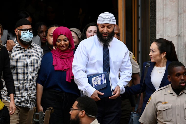 Adnan Syed (center right) leaves the courthouse after a hearing on Sept. 19 in Baltimore.