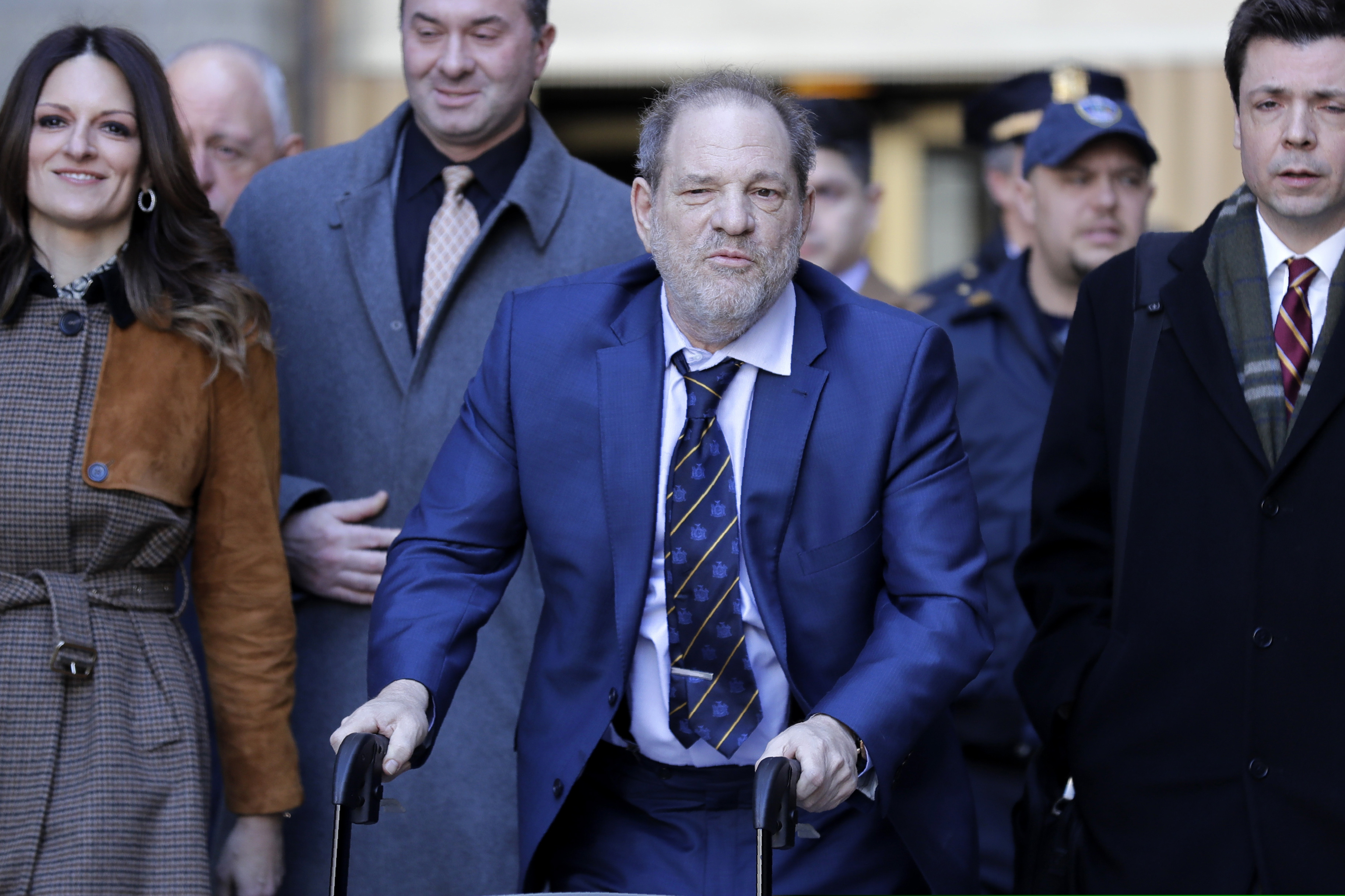 Harvey Weinstein, center, leaves a Manhattan courthouse after closing arguments in his rape trial in New York, Friday, Feb. 14, 2020.