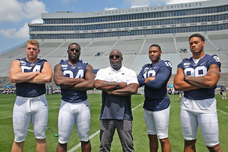 Penn State football defensive linemen Robert Windsor (54), Shane Simmons (34), Shaka Toney (18) and Yetur Gross-Matos (99) with defensive line coach Sean Spencer during the program's annual Media Day last month.
