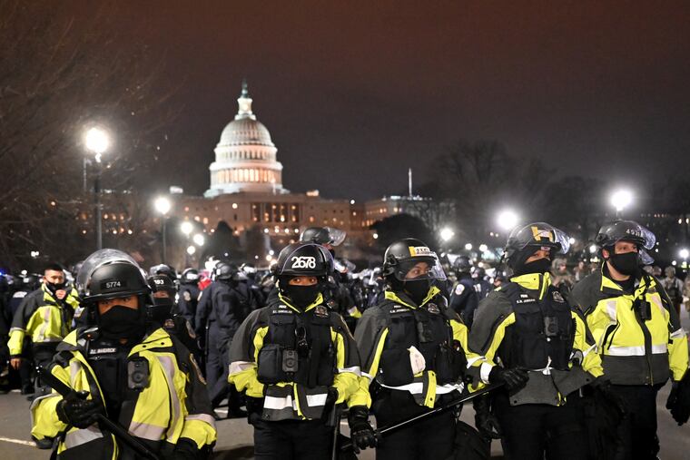 Police clear the area around the U.S. Capitol on Wednesday after pro-Trump supporters swarmed the building in an effort to prevent Congress meeting in joint session to confirm Joe Biden's presidential win.