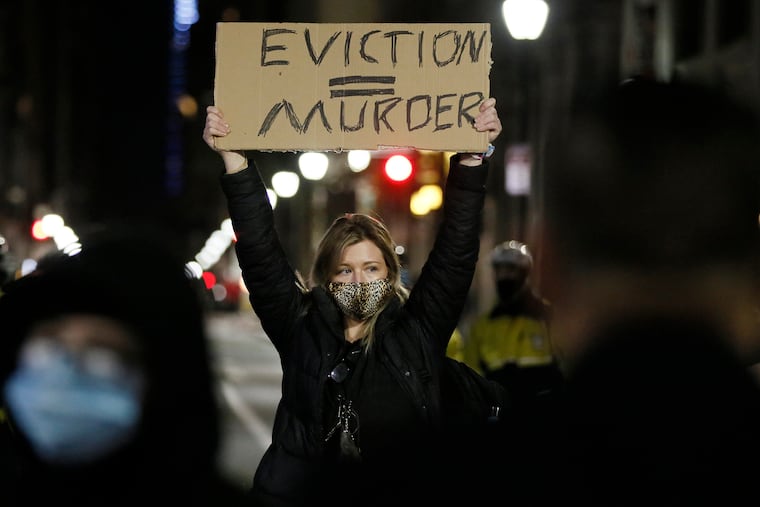 Veronica Carden, of Philadelphia, faced police as she took a stand in the middle of Walnut Street when advocates for the homeless created an encampment outside the Holiday Inn at 1305 Walnut St. on Dec. 10. Residents at the Holiday Inn, the city’s “Quarantine Hotel” and COVID-19 prevention hotel, received notices from the City of Philadelphia Office of Homeless Services declaring an eviction date of Dec. 15 for all residents. Thousands of Pennsylvanians are staring down the possibility of eviction amid the pandemic.