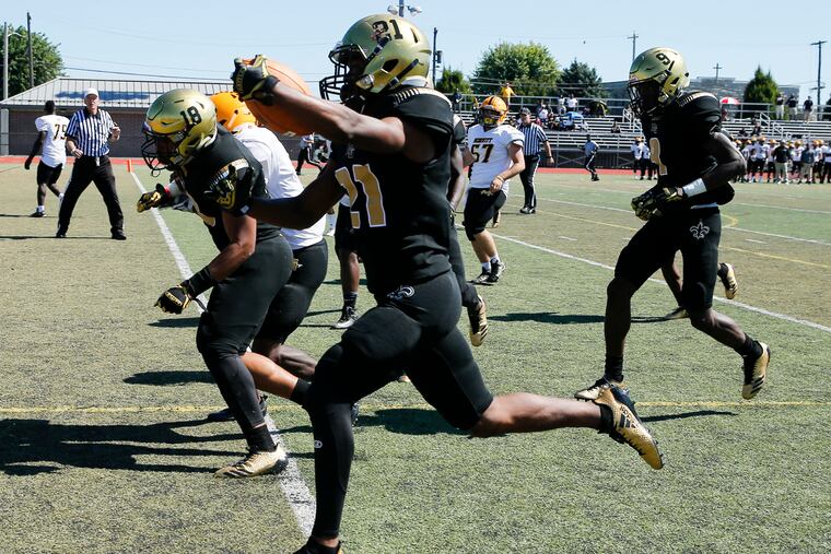 Neumann-Goretti all-purpose standout Tysheem Johnson, shown here scoring a touchdown last season as a sophomore, has helped the Saints to a 3-0- record.