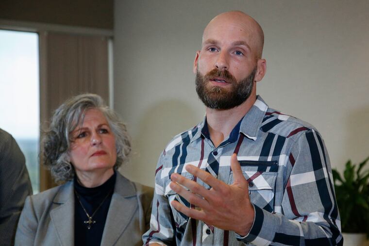 Michael Behenna, right, answers a question during a news conference Wednesday, May 8, 2019, in Oklahoma City. At left is his mother, Vicki Behenna. Behenna has been pardoned from his 2009 conviction for killing an Iraqi prisoner. (AP Photo/Sue Ogrocki)