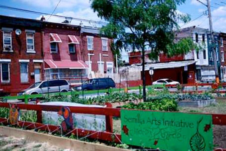 The "Children's Garden" built by Pedro Ospina and Betsy Casanas on a lot once littered by glass and soiled mattresses. (Tom Stoelker / Staff Photographer)