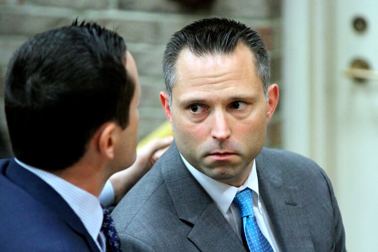 FILE - In this June 12, 2018 file photo, Thomas Tramaglini, right, the Kenilworth Schools superintendent accused of defecating on the track at Holmdel High School, makes his initial appearance in Holmdel Municipal Court in Holmdel, N.J. Tramaglini has sued the local police department for releasing his mug shot to the news media. He claims Holmdel police violated his constitutional rights by taking the picture and then releasing it after he was issued summonses last year. The suit seeks unspecified monetary damages.(Thomas P. Costello/The Asbury Park Press via AP, Pool)