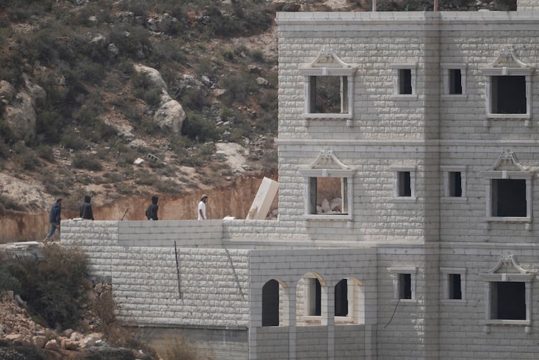 Israeli settlers enter Palestinian properties in the occupied West Bank village of Qusra, Saturday, Aug. 29, 2026.