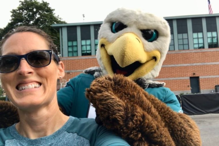 Philadelphia firefighter and Red Paw founder Jen Leary with Eagles mascot Swoop, prior to social distancing guidelines.