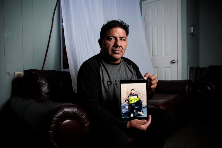 Lenin Acurio Suarez holds a photograph of his brother Victor, at his home on Wednesday in Seaford, Del. Victor was arrested by ICE on Sept. 22.
