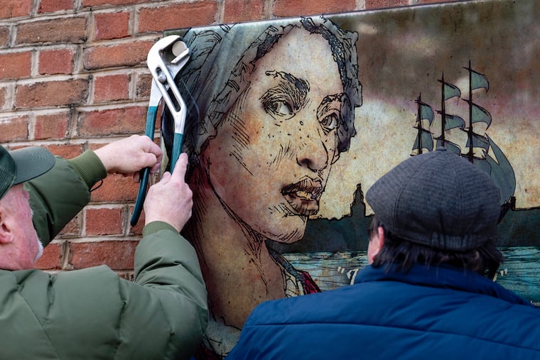 Workers remove the panel for Ona Judge and other displays about slavery at the President’s House site in Independence National Historical Park on Jan. 22. Philadelphia is the wrong place for historical amnesia, writes Jim Downs.