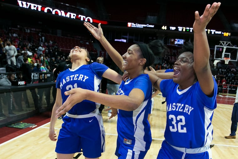 The Mastery Charter North girls team celebrateas after their victory over Imhotep Charter in the Philadelphia Public League Championship for girls at the Liacouras Center on Feb. 22, 2020. L-R: Nashiah Thompson-King, Jaylah Robinson, and Ayanna Eldridge.