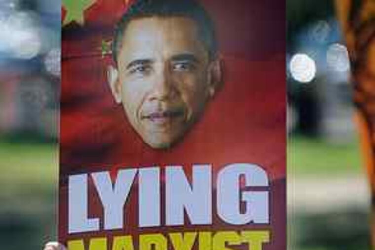 John Maxwell of Houston takes part in a protest near Rudder Auditoriumon the Texas A&M campus, where President Obama spoke Friday.
