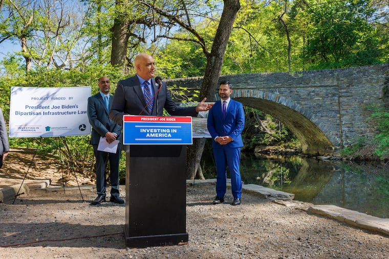 Federal highway officials, including Shailen Bhatt, the administrator of the Federal Highway Administration, announced $14.2 million grant to refurbish two bridges over the Wissahickon Creek.