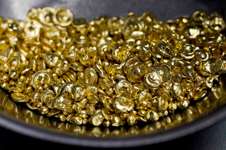 Pure gold casting grain, above, at a N.Y. jewelry store. Gold was at $1308.37 on Wednesday but could rise in a stock market pullback.