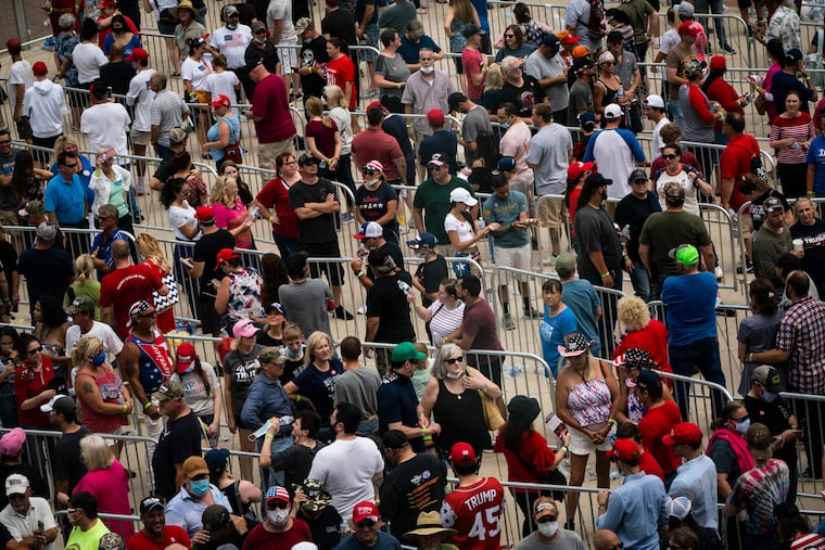 Supporters wait in lines before President Trump arrives for a rally at the BOK Center on Saturday.