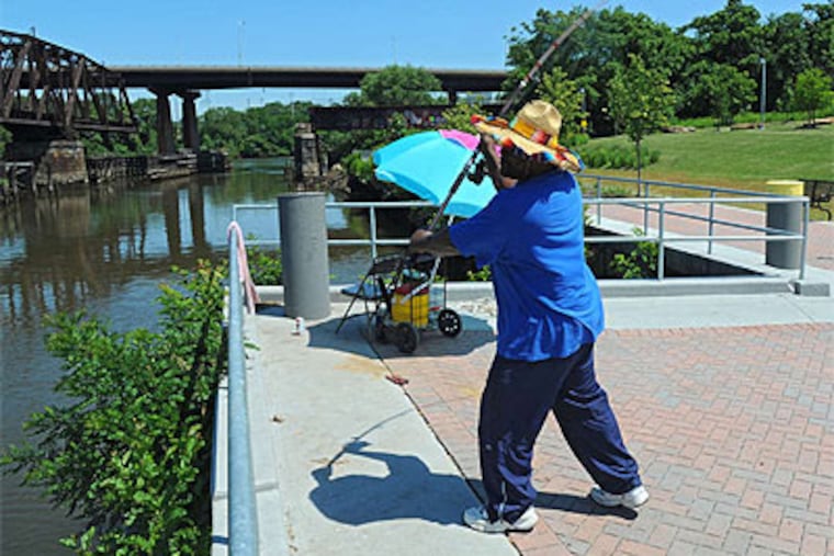 "The water's crappy," Darryl McMillian said, but he was still willing to eat a friend's catch. (Clem Murray / Staff Photographer)