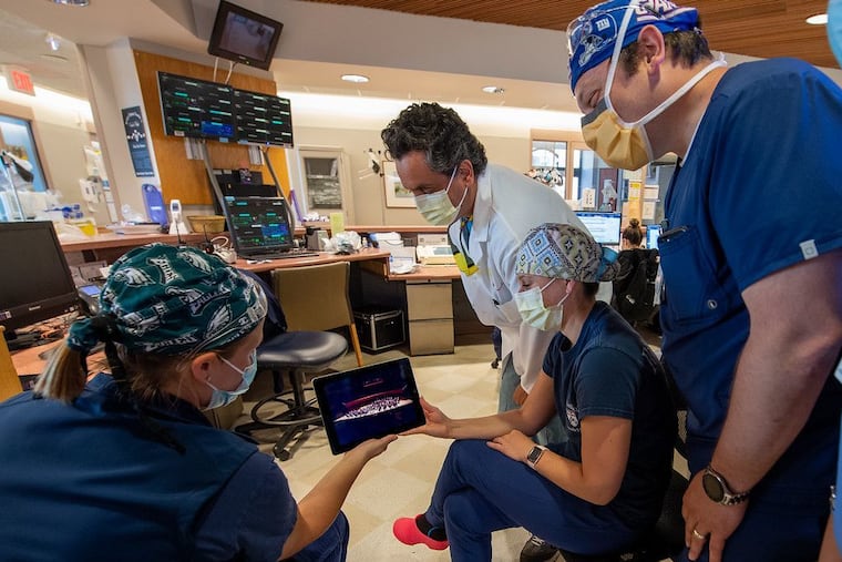 At the Hospital of the University of Pennsylvania, Dr. Jose Pascual (in white coat) with medical staff look at the Philadelphia Orchestra's new channel being offered in Penn Medicine facilities.