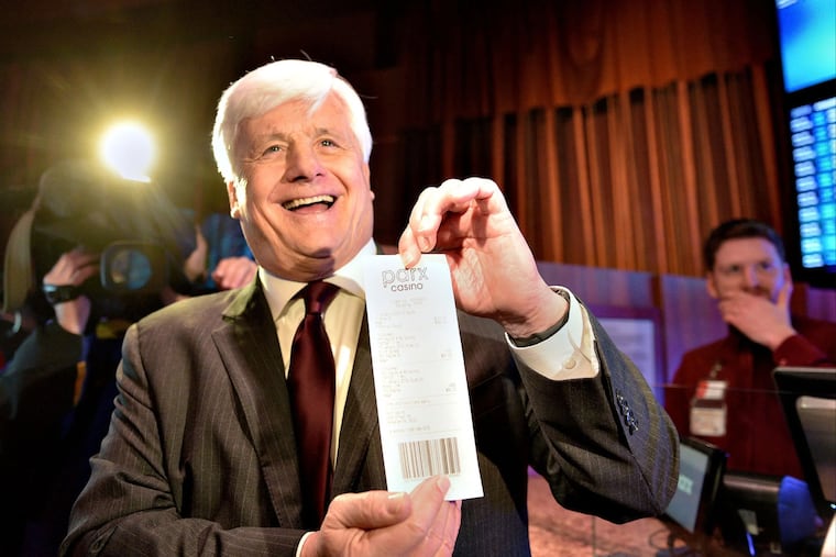 State Sen. Tommy Tomlinson (R., Bucks) is shown here holding a sports betting ticket at Parx Casino. Tomlinson’s office asked lobbyists for the casino to write language for a bill to ban skill games.