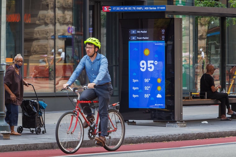 A bus shelter digital billboard displays a temperature of 95 degrees at 11th and Market Streets on Monday afternoon.