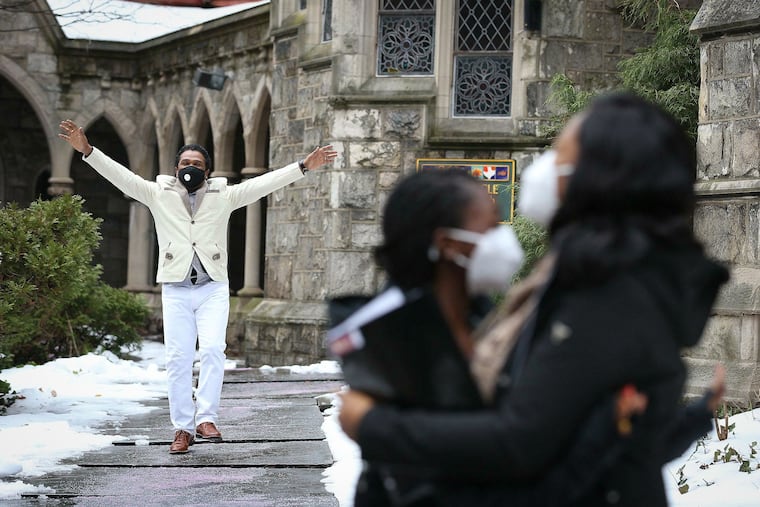 Clive Thompson (left) dances in celebration as his wife, Oneita, embraces their daughter, Christine, outside the Tabernacle United Church in Philadelphia on Dec. 21, 2020. The undocumented Jamaican couple left the church after more than two years of living in sanctuary within, after the federal government dropped its deportation case against them.