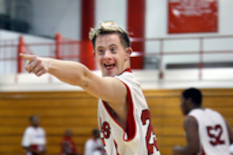 Cherry Hill East senior Brad Hennefer points to a fan after scoring against Pennsauken. His coaches say he may be the only boy with Down syndrome playing U.S. varsity basketball.
