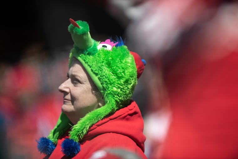 A Phillies' fan embraces the chill at Citizens Bank Park in April of last year. Monday night will be a red-sweater situation when the Phils host the Diamondbacks in the pennant series.