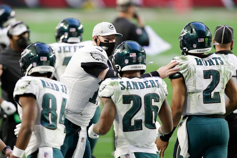Carson Wentz congratulates Jalen Hurts Sunday after the rookie scored on a 7-yard touchdown run.