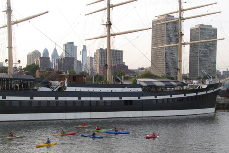 Kayakers dabble in the Delaware along the Moshulu, moored at Penn's Landing. The Pennsylvania Environmental Council and others are promoting the lower Delaware for its recreational value.